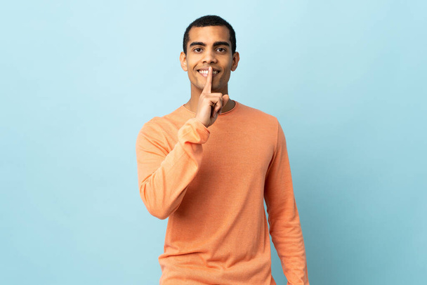 Uomo afroamericano su sfondo isolato mostrando un segno di silenzio gesto mettendo il dito in bocca
 - Foto, immagini