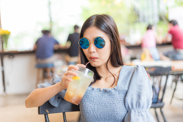 Beautiful women sittinfg in cafe with ice summer soda drink women in cafe - Photo, image