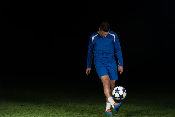 Professional Soccer Player Kicking Ball Isolated On Black - Foto, Imagem