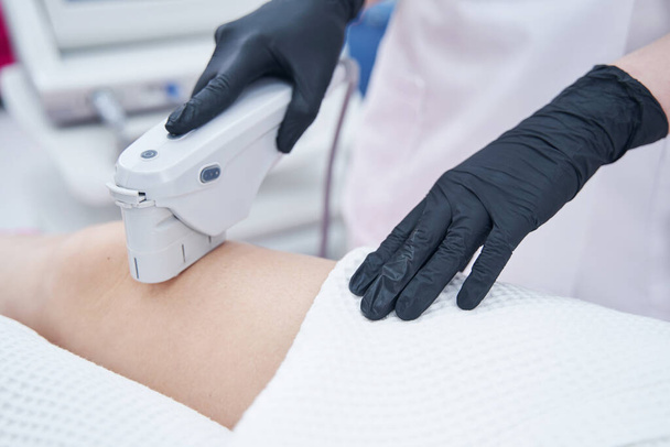 Woman receiving ultrasound lifting treatment in cosmetology clinic - Φωτογραφία, εικόνα