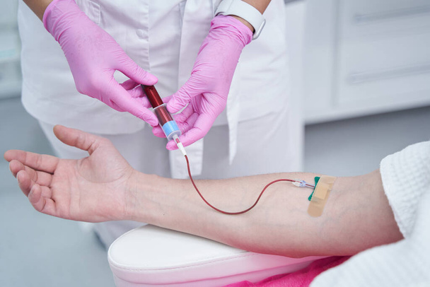 Close up of medical worker getting sample of plasma - Photo, Image