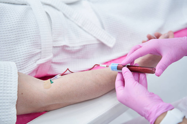 Professional medical worker getting blood for checkup - Zdjęcie, obraz