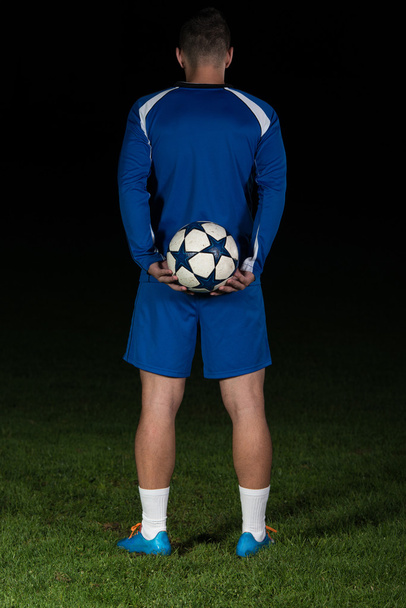 Back View Of Soccer Player On Black Background - Fotografie, Obrázek