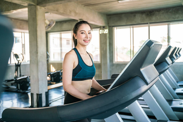 Attractive asian women running on treadmill sport gym healthy life style - 写真・画像