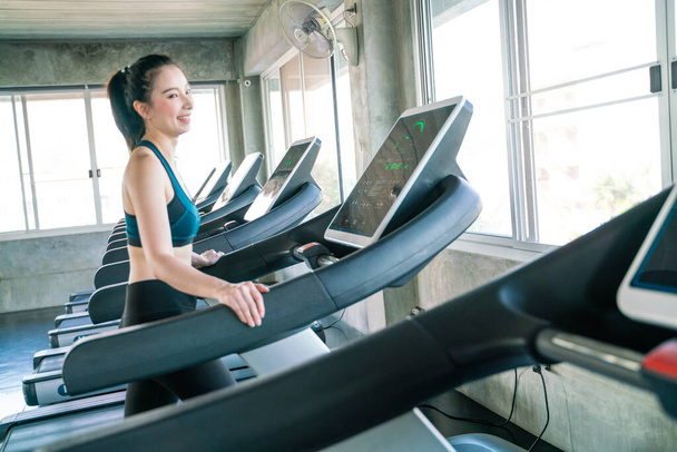Attractive asian women running on treadmill sport gym healthy life style - Fotoğraf, Görsel
