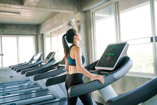 Attractive asian women running on treadmill sport gym healthy life style - Фото, зображення