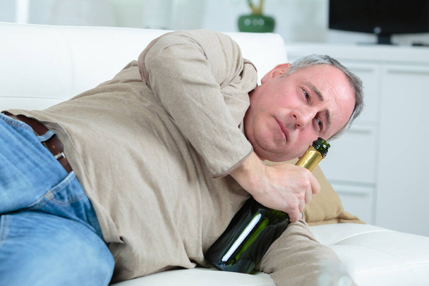 old man drinking caused by depression - 写真・画像