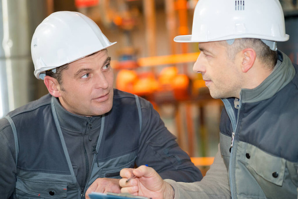 two industrial workers in discussion - Photo, image