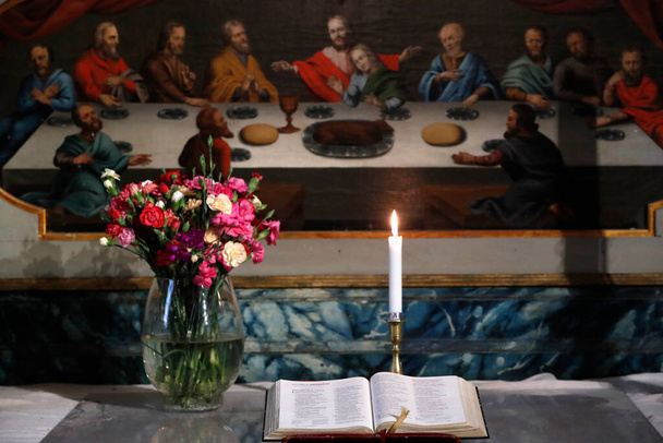 Our lady church ( Var Frue Church ). Church candle and open bible on altar.  Trondheim. Norway.  - Foto, afbeelding