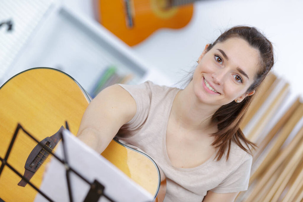 portrait of young lady with guitar - Photo, Image