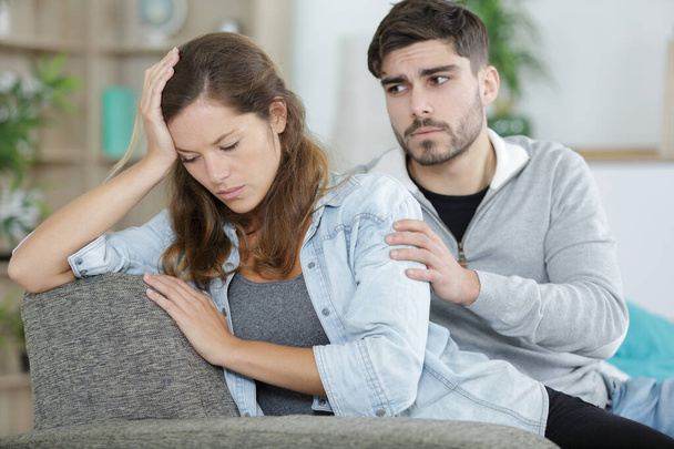 upset couple sitting after arguing on couch - Photo, image