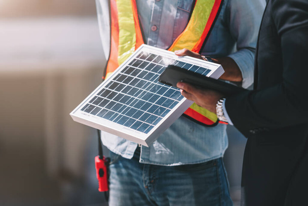 Cropped picture of engineer technician and CEO executive business people plan a project to build a solar panel for the building under construction. clean and green alternative energy concept - 写真・画像