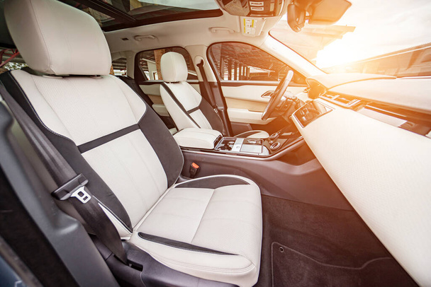 Modern luxury prestige car interior, dashboard, steering wheel. Orange red perforated leather interior. - Photo, image