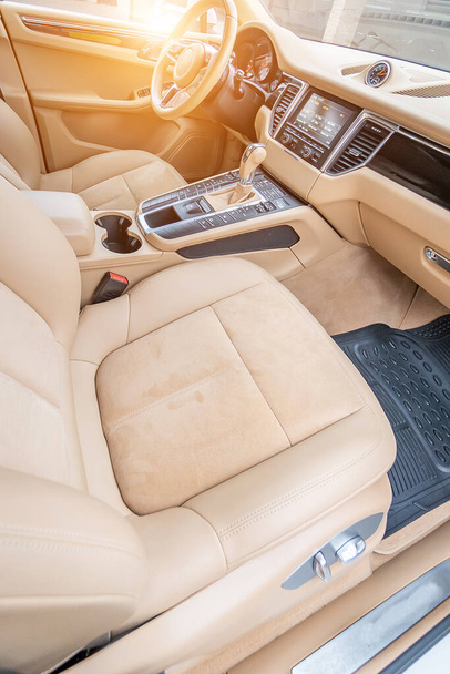 Car interior luxury. Beige comfortable seats, steering wheel, dashboard, climate control, speedometer, display, wood decoration light - Valokuva, kuva