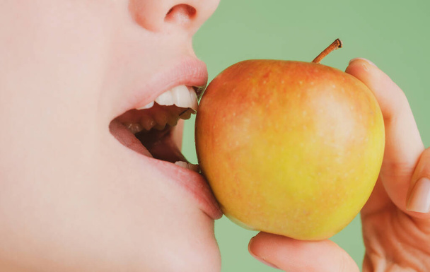 Dental Care. Healthy white teeth closeup with an apple. - 写真・画像