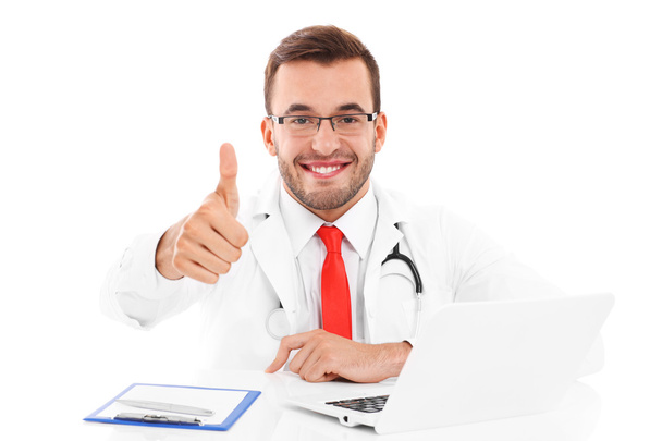 Doctor with laptop and documents showing ok sign - Фото, зображення