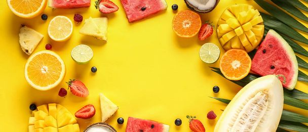 Frame made of sweet tropical fruits on yellow background - Fotoğraf, Görsel