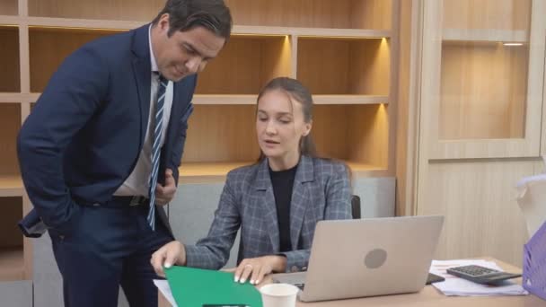 Businesswoman and businessman meeting with looking laptop computer and discussion together, business man and woman is partnership talking about work, manager and executive planning for success. - Materiał filmowy, wideo