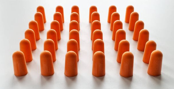 Orange foam ear plugs isolated on white background - Фото, зображення