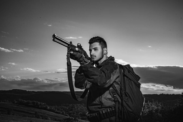 Hunter with shotgun gun on hunt. Hunting Equipment for sale. Hunter aiming rifle in forest. Mountain hunting. - Foto, Bild