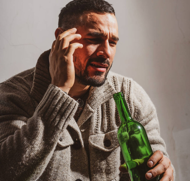 Alcoholic man with bottles wine cry. Depressed crying man. Drunk men drinking alcohol feeling lonely and desperate in emotional stress. - Фото, зображення