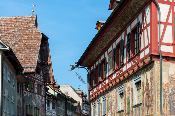 Historical tenement house (apartment building) with facade paintings and half timbered walls in an old town in Swiss city Stein am Rhein in Switzerland  - Photo, image