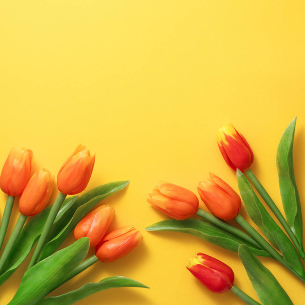 Mother's day background concept. Top view design of holiday greeting tulip flower bouquet on bright yellow table with copy space. - Zdjęcie, obraz