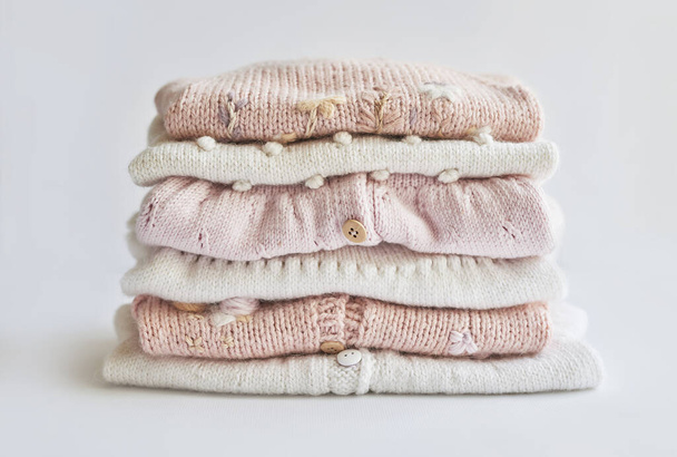 Stack of knitted clothes. Baby clothes. Needlework, hobby, knitting, handwork - Fotoğraf, Görsel