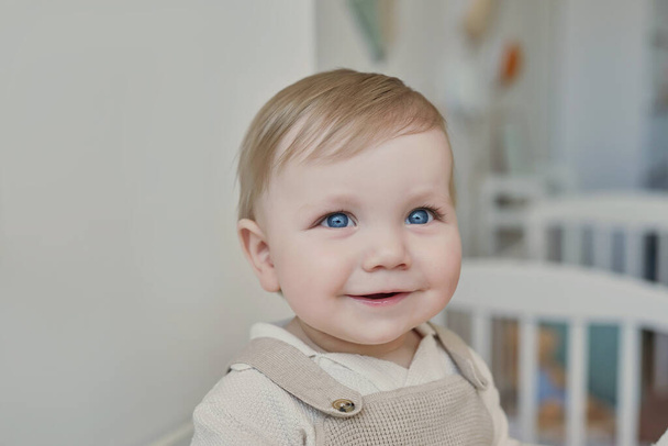 Wonderful baby boy with blue eyes. Child playing with toys in nursery. Early development, kindergarten, nursery, playroom. Children's Day, Mother's Day. - Foto, afbeelding