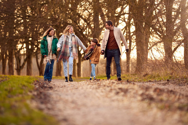 Family Holding Hands On Walk Through Autumn Countryside Together - Fotoğraf, Görsel