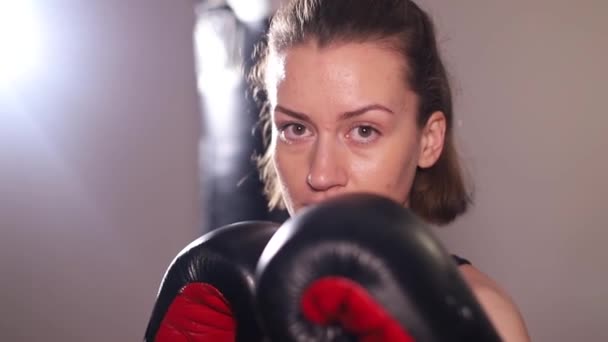 Агрессивная женщина-боксер практикует удары на тренировках. Быстрые движения руками, борьба с тенью - Кадры, видео