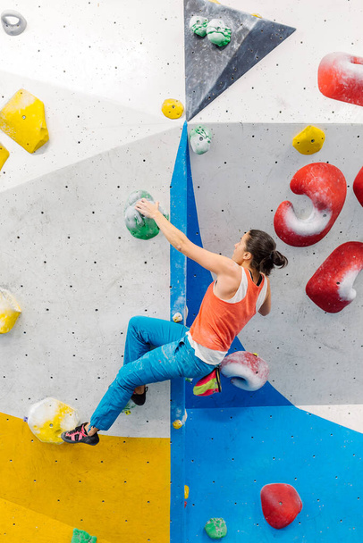 Young Woman rock climbing indoors. - Fotoğraf, Görsel