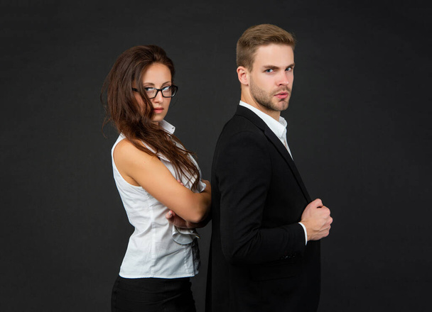 successful businessman and brunette businesswoman on black background, partners - Fotó, kép