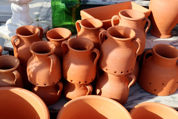 Clay jugs are stacked on top of each other. Ceramic tableware. - Photo, Image