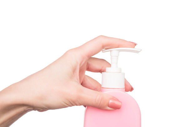 female hands press soap bottle with copy space - 写真・画像