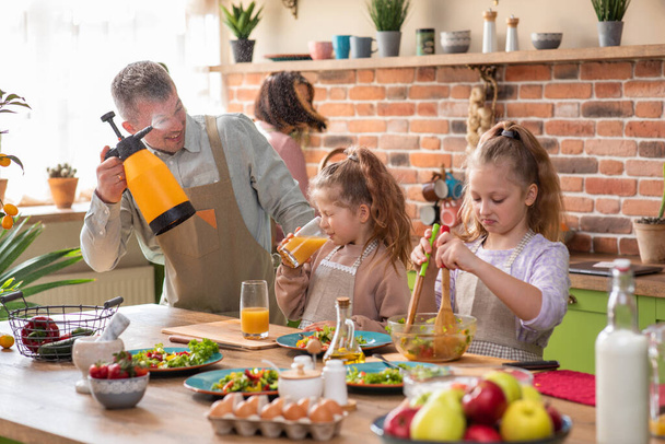 Family preparing food in kitchen - Foto, Imagen