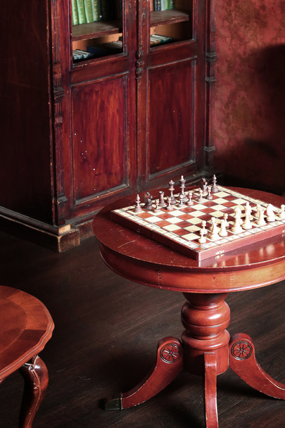 Retro room interior witg cupboard books chess table - Photo, Image