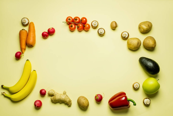 Top view of frame from whole fruits and vegetables on yellow background  - Foto, Imagem