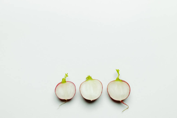 Top view of cut radishes on white background flat lay - Foto, Imagem