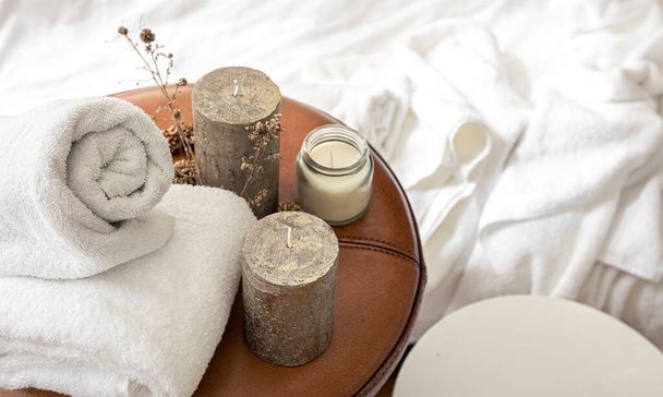 Spa composition with candles and towels on a blurred background. - Photo, image