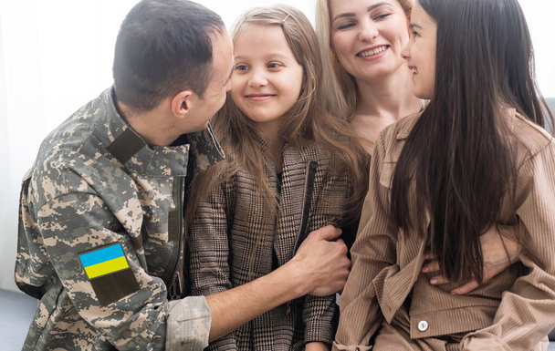 Happy Ukrainian soldier in military, cheerful daughter, Ukrainian veterans of Russian-Ukrainian, Independence Day - Photo, Image