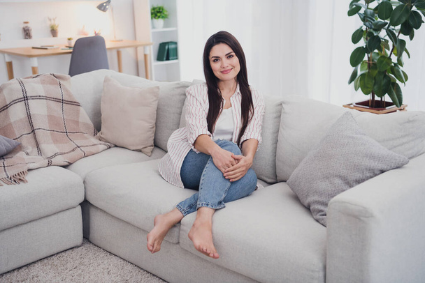 Portrait of attractive cheerful healthy long-haired woman sitting on cosy comfy divan day off at home indoors - Fotoğraf, Görsel