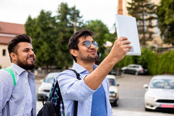 The joyful group of multiethnic students taking a selfie outdoors - Foto, afbeelding
