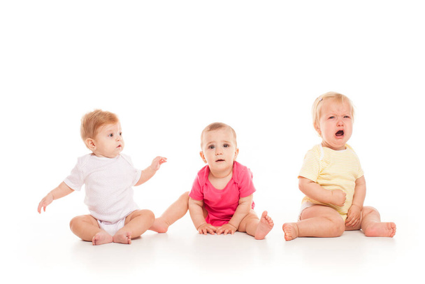 Three babies sitting isolated on the white - Foto, imagen