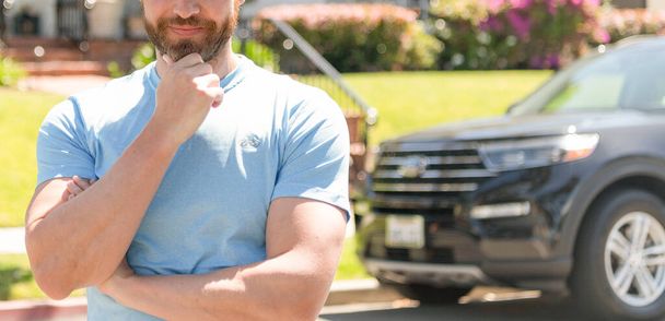cropped guy standing next to car and house in neighborhood. copy space - Photo, image