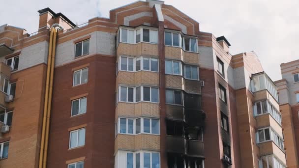 Irpin, burnt-out windows after being hit by shells in a multi-storey residential building. Consequences of the war in Ukraine. - Video