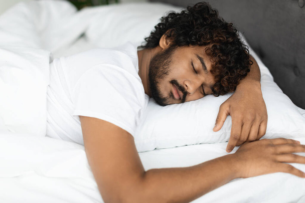 Closeup portrait of peaceful indian guy sleeping in bed - Zdjęcie, obraz