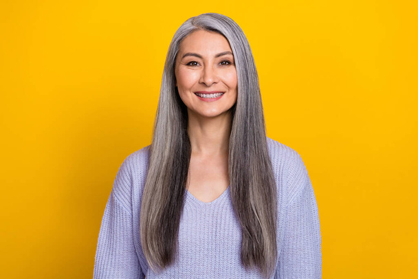 Photo of mature cheerful pretty skilled business lady in comfy knitted sweater isolated on yellow color background - Photo, image