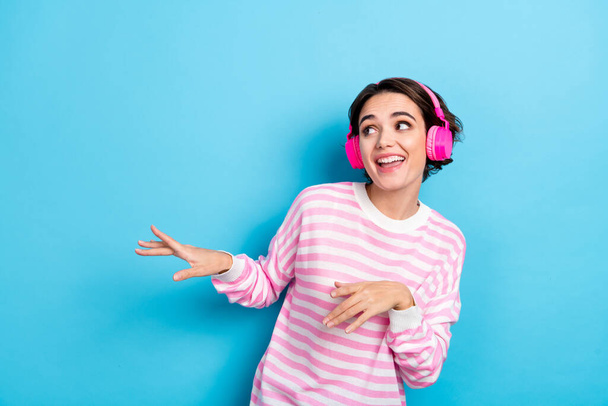 Photo of cute good mood lady look empty space fooling around have fun dancing isolated on blue color background - Foto, Bild