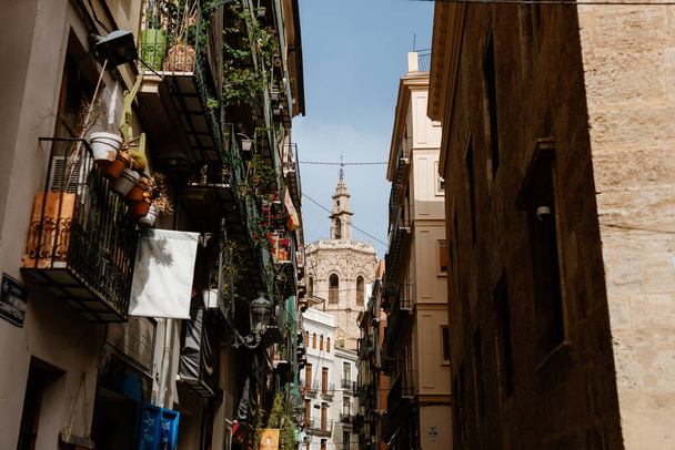 Valencia Spain; August 11, 2021: Street in the Carmen neighborhood in Valencia with the Miguelete tower in the background. - Fotó, kép